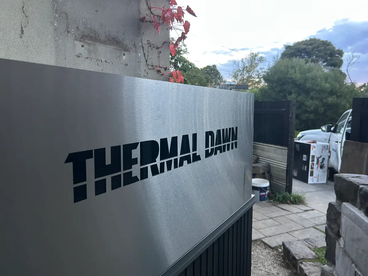 The Thermal Dawn brand plate on the installed enclosure