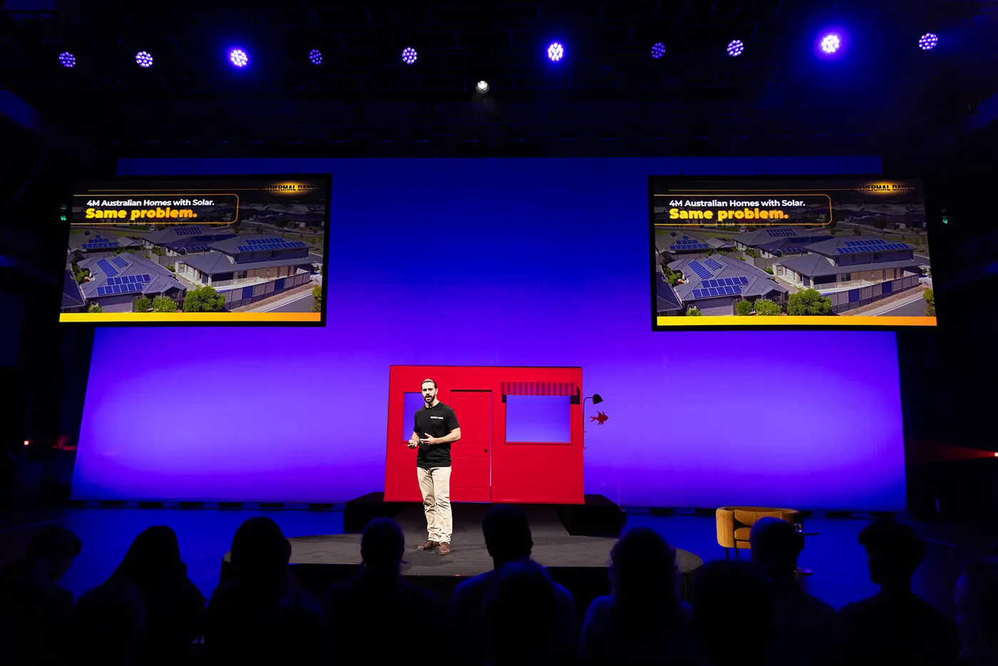 Nick Zeniou on stage at Startmate Demo Day, presenting the problem: four million Australian homes with solar
